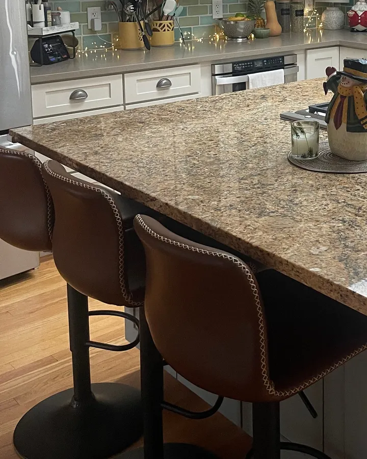 Clean granite island and bar stools in a home Rosy cleaned