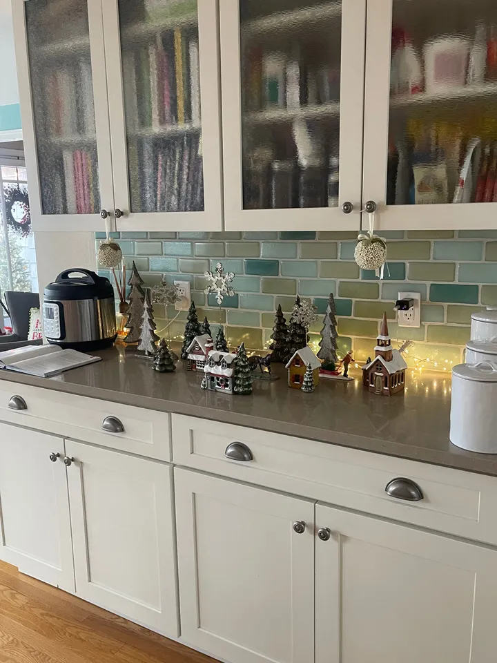 White cabinets and tiled backsplash in a home Rosy cleaned, decorated for the holidays
