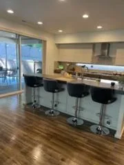 Open kitchen with bar stools, cleaned by Rosy