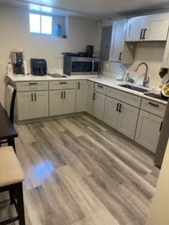 Kitchen with gray cabinets, cleaned by Rosy