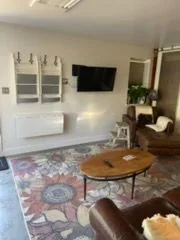 Living room with a floral rug, cleaned by Rosy