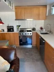 Kitchen with wood cabinets and subway tile, cleaned by Rosy