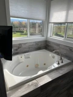 Bathroom with a jetted tub, cleaned by Rosy