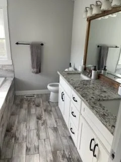 Bathroom vanity and gray plank floor, cleaned by Rosy