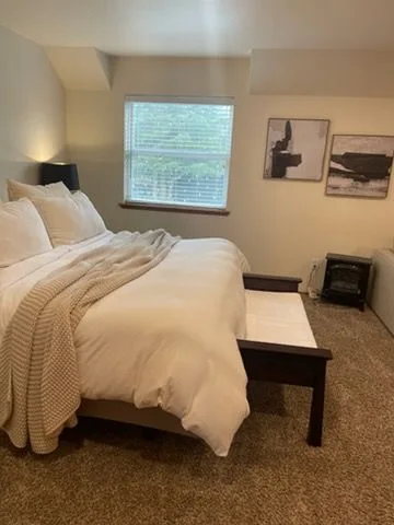 Bedroom with white bedding, cleaned by Rosy