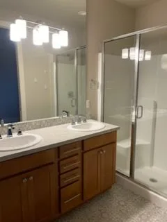 Double vanity and glass shower, cleaned by Rosy