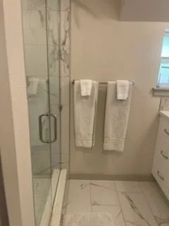 Glass shower and marble floor, cleaned by Rosy