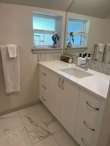 Bathroom vanity with folded towels, cleaned by Rosy